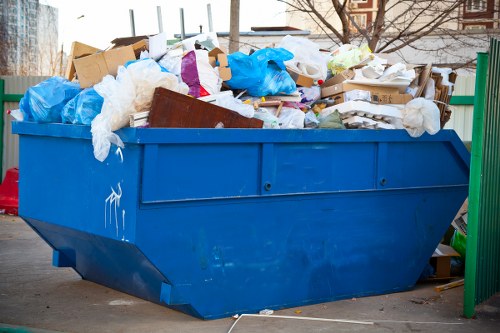 Photograph of a house clearance scene with crew assessing items